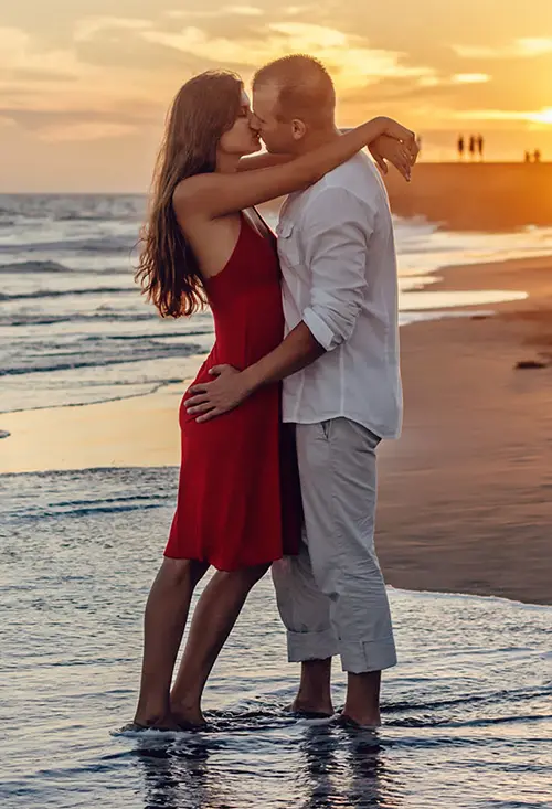 Attractive couple embracing on the beach